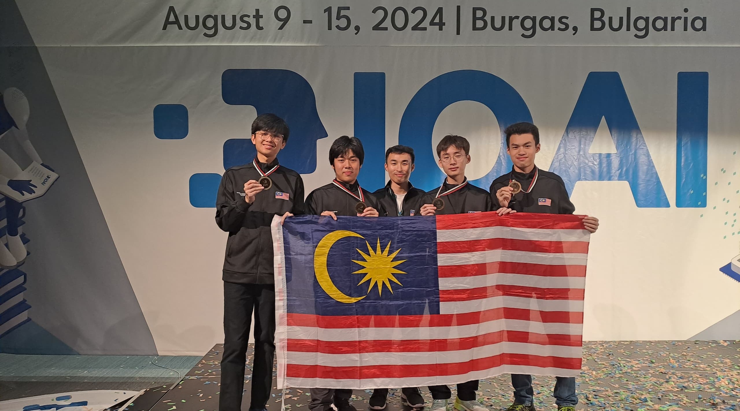 Malaysian team picture with bronze medal cover